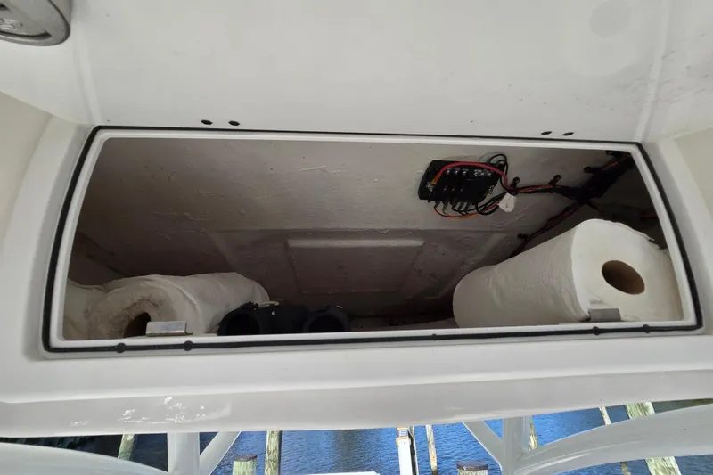 Slide: The Image of Storage compartment in 2022 Sea Fox 249 Avenger boat with paper towels and wiring. - 29