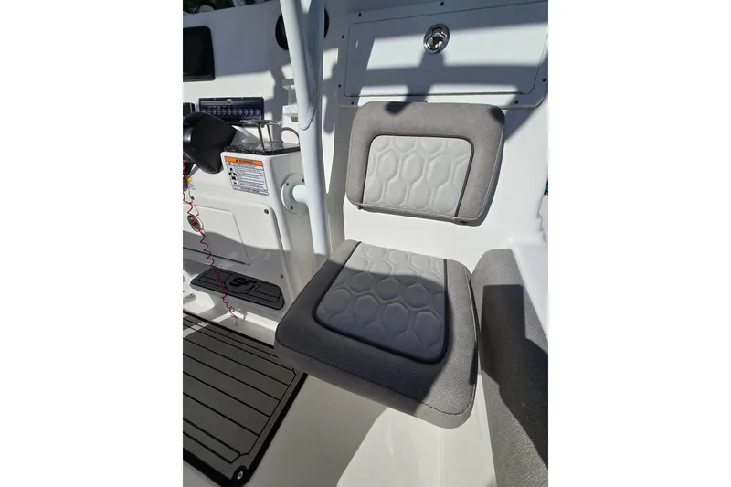 Slide: The Image of 2022 Sea Fox 249 Avenger boat interior with cushioned seating and control panel. - 31