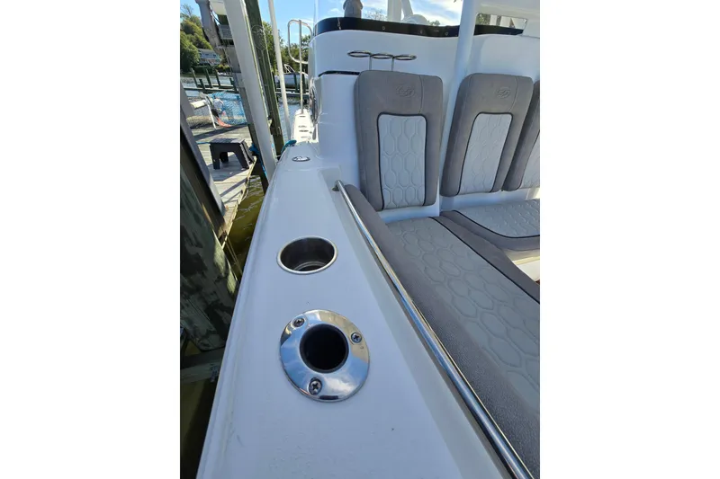 Slide: The Image of 2022 Sea Fox 249 Avenger boat interior with cushioned seating and rod holders. - 9