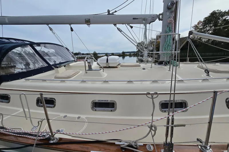 Slide: The Image of Deck view of a 2001 Island Packet 420 sailboat, featuring rigging and portholes. - 10
