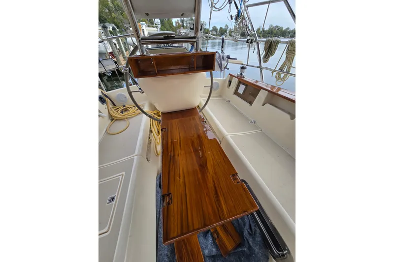 Slide: The Image of 2001 Island Packet 420 sailboat cockpit with polished wood and nautical equipment. - 17