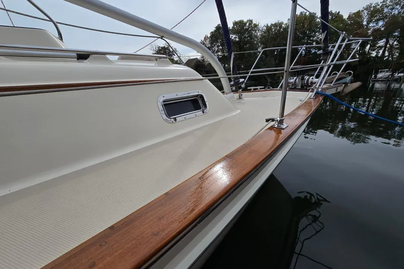 Slide: The Image of Island Packet 420 sailboat, 2001 model, docked with polished wood trim and stainless steel railings. - 2