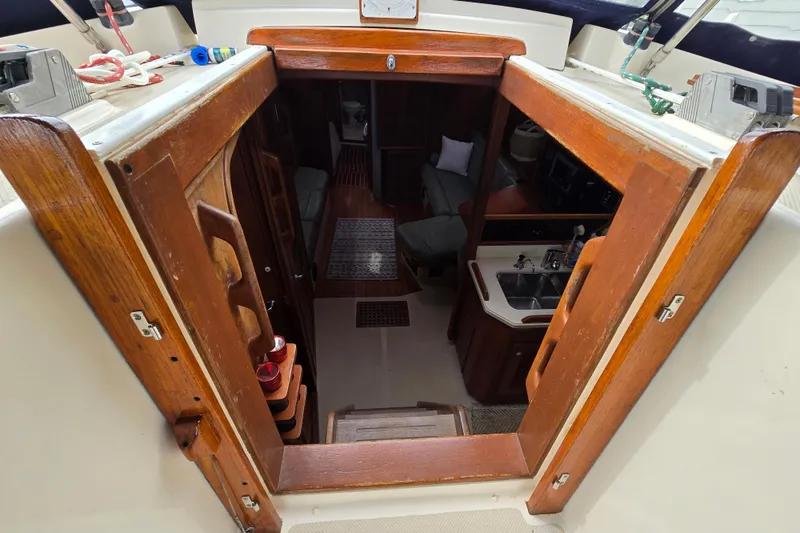 Slide: The Image of Cockpit of 2001 Island Packet 420 sailboat with ropes and winches, docked at marina. - 25