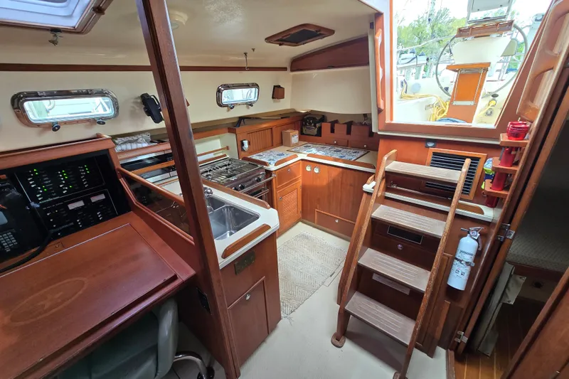 Slide: The Image of Interior of 2001 Island Packet 420 sailboat featuring kitchen and navigation area. - 31