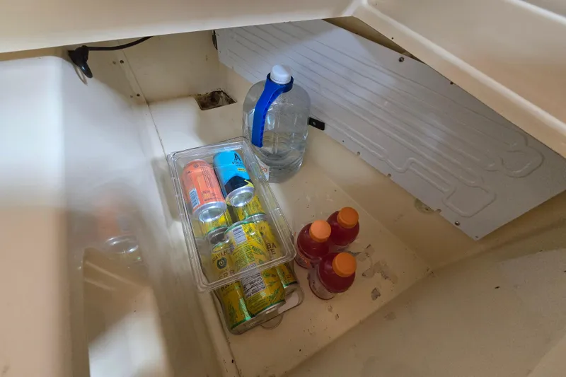 Slide: The Image of Beverage storage in Island Packet 420 sailboat, featuring cans and bottles, 2001 model. - 34