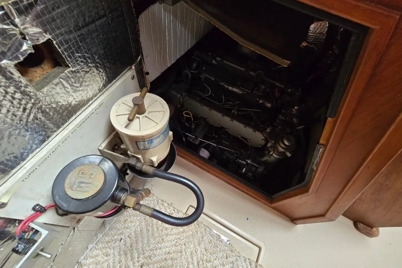 Slide: The Image of Engine compartment of a 2001 Island Packet 420 sailboat, showing mechanical components. - 41