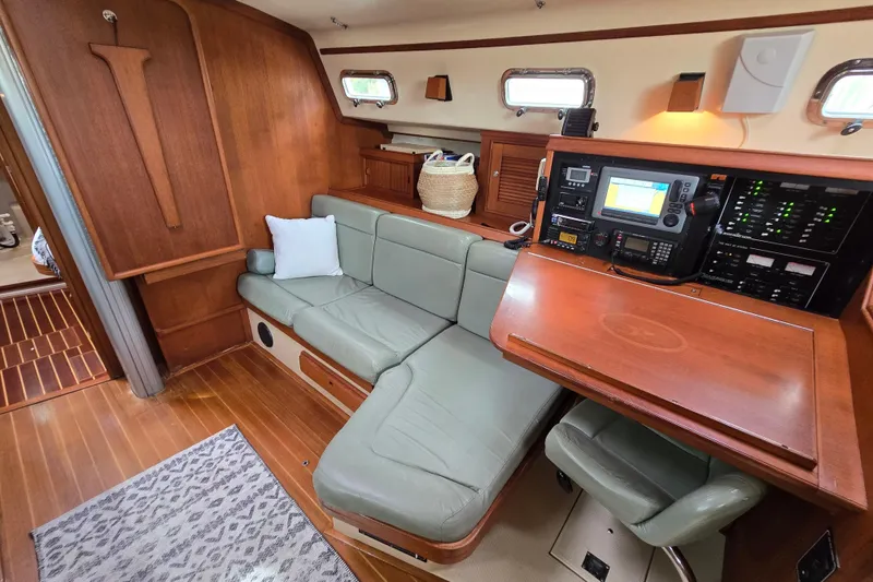 Slide: The Image of Interior of 2001 Island Packet 420 sailboat with navigation station and seating area. - 48
