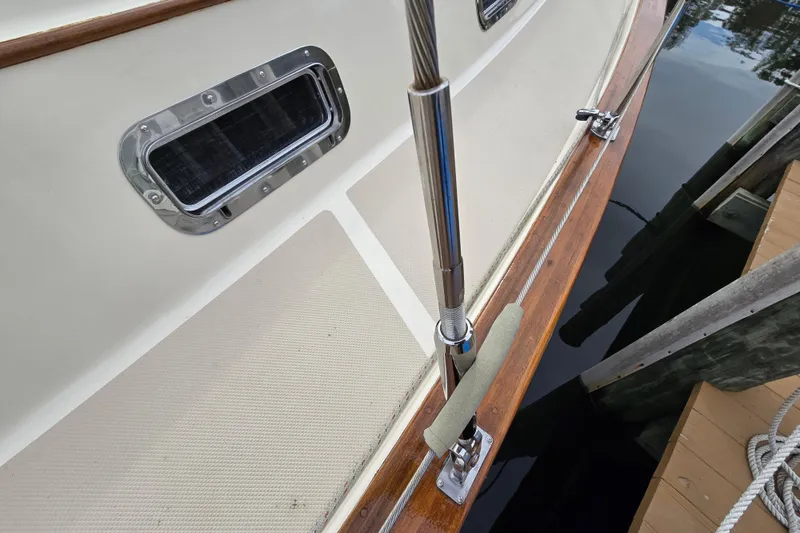 Slide: The Image of 2001 Island Packet 420 sailboat deck with polished wood and stainless steel fittings. - 7
