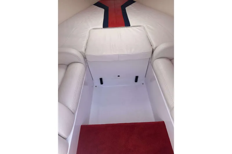 Slide: The Image of Interior of a 2006 Donzi 26 boat with white seating and red carpet. - 16