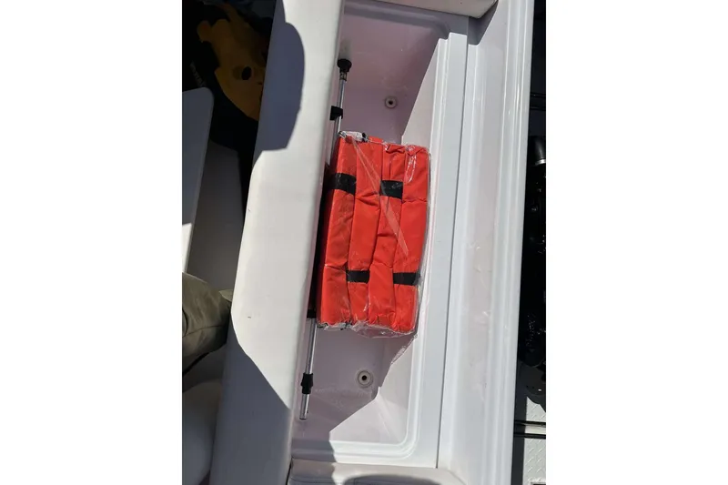 Slide: The Image of Storage compartment with life jackets on a 2006 Donzi 26 boat. - 18