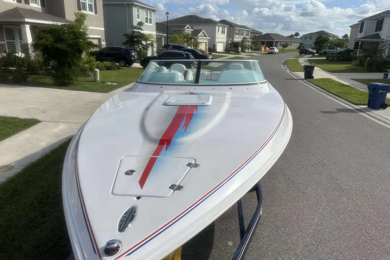 Slide: The Image of 2006 Donzi 26 boat with sleek design parked in suburban neighborhood street. - 3