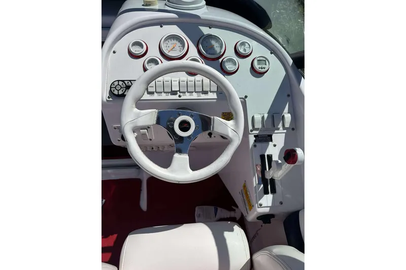 Slide: The Image of 2006 Donzi 26 boat dashboard with steering wheel and control panel. - 8