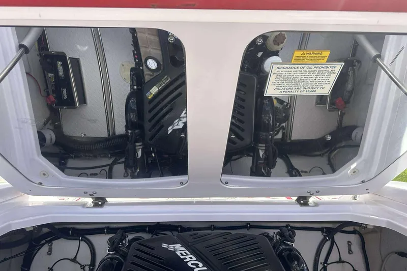 Slide: The Image of Engine compartment of a 2006 Donzi 26 boat, featuring a Mercury engine. - 12