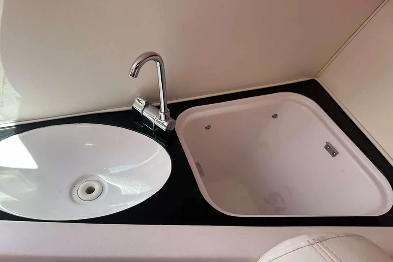 Slide: The Image of Sink and faucet in 2006 Donzi 26 boat interior, featuring a sleek design. - 13