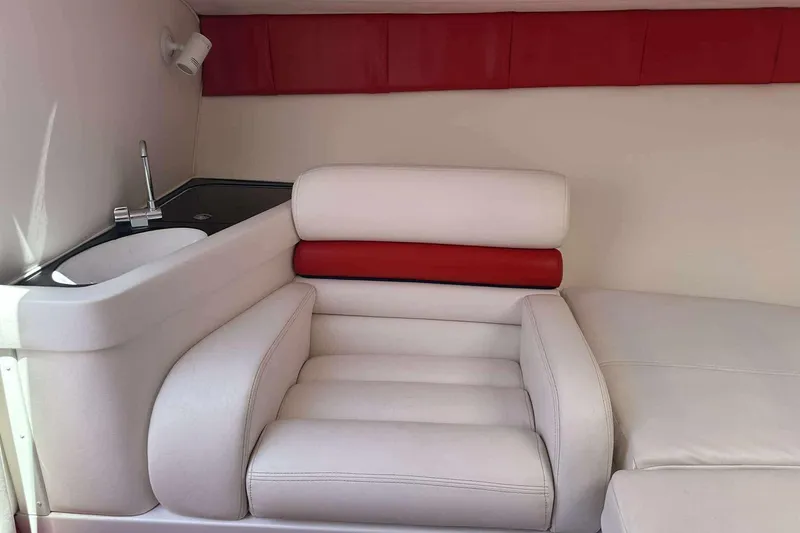 Slide: The Image of Interior of 2006 Donzi 26 boat with white and red seating, sink, and faucet. - 15