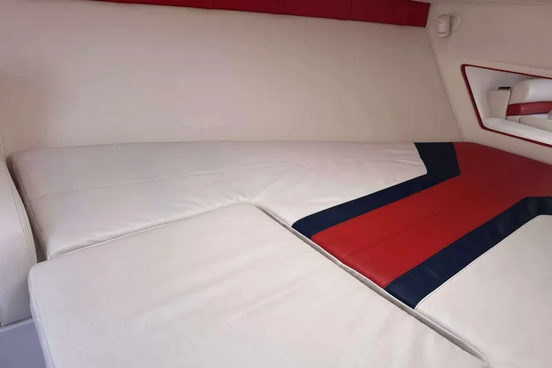 Slide: The Image of 2006 Donzi 26 boat interior with white, red, and blue upholstery design. - 17