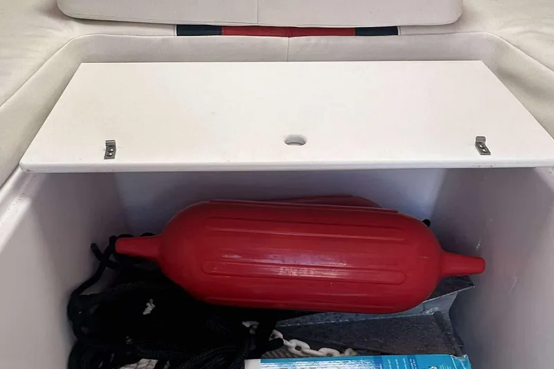 Slide: The Image of Storage compartment on a 2006 Donzi 26 boat with red fender and ropes. - 19