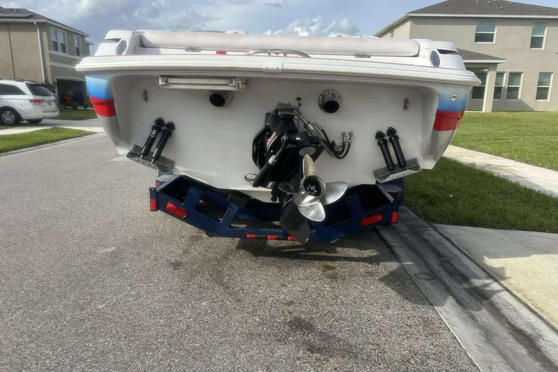 Slide: The Image of Rear view of a 2006 Donzi 26 boat on a trailer in a suburban neighborhood. - 6