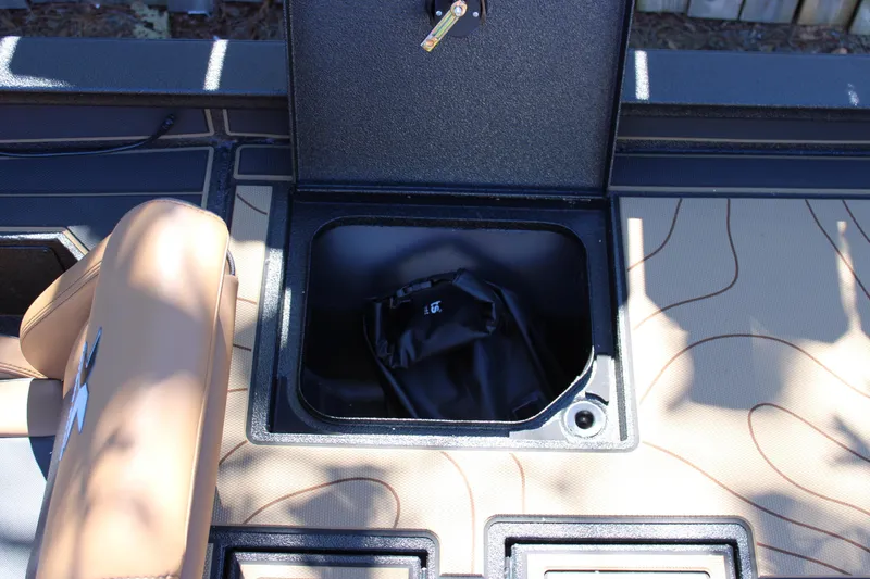 Slide: The Image of Open storage compartment in 2026 Xpress X21 Pro boat interior. - 10