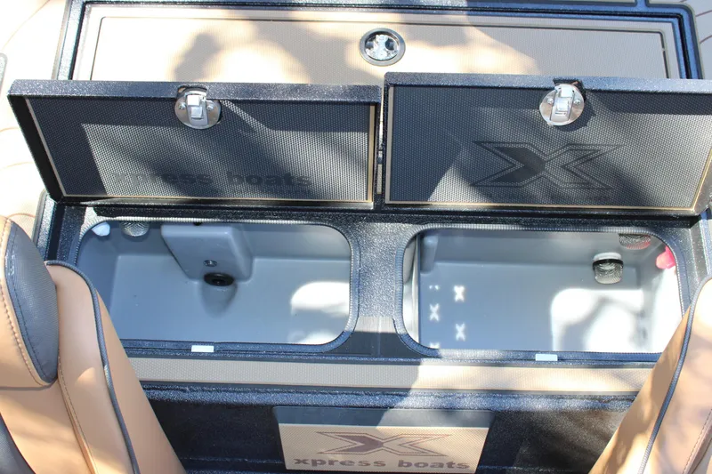 Slide: The Image of Open storage compartments on 2026 Xpress X21 Pro boat, featuring secure latches and spacious interior. - 11