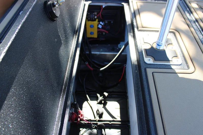 Slide: The Image of Open compartment of 2026 Xpress X21 Pro boat showing internal wiring and components. - 14