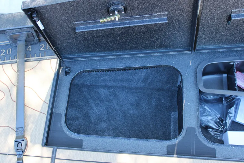 Slide: The Image of Open storage compartment in 2026 Xpress X21 Pro boat, featuring secure lock and organized interior. - 17