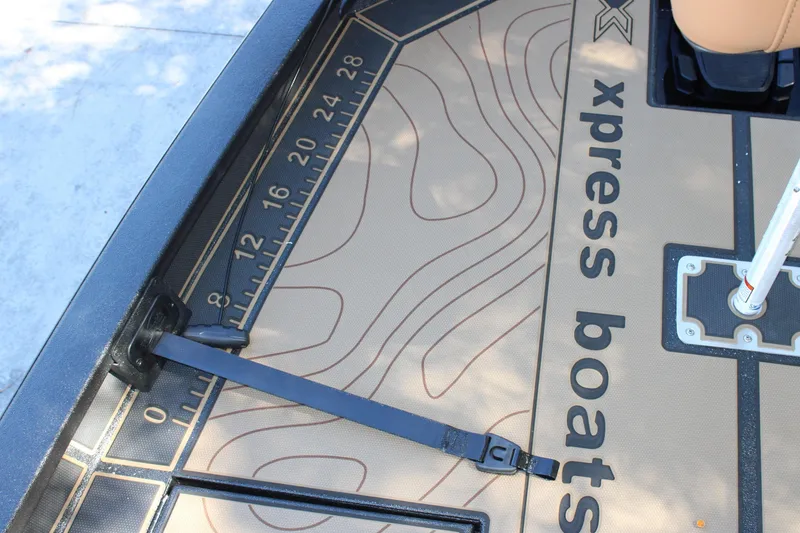 Slide: The Image of Xpress X21 Pro 2026 boat deck with measuring ruler and strap detail. - 18