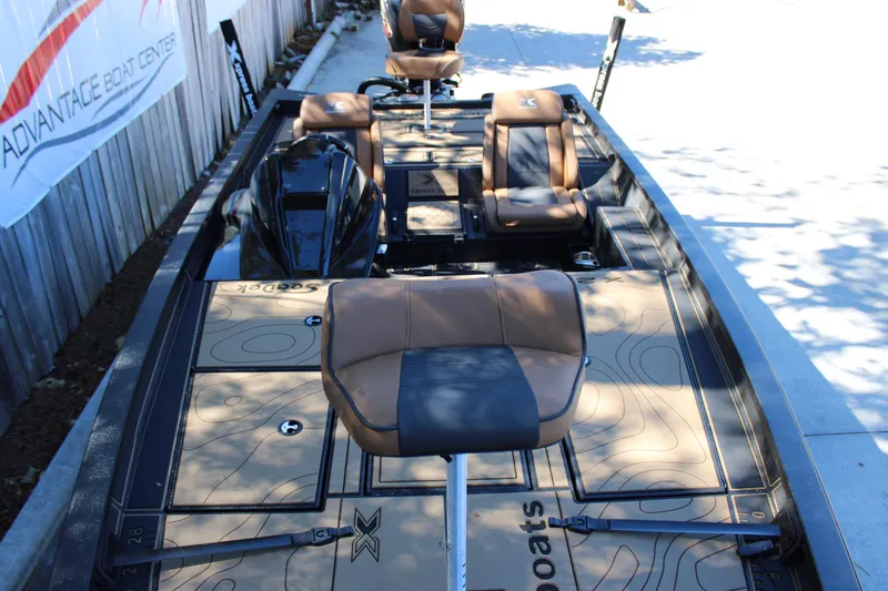 Slide: The Image of 2026 Xpress X21 Pro boat with brown seating and detailed deck design. - 21