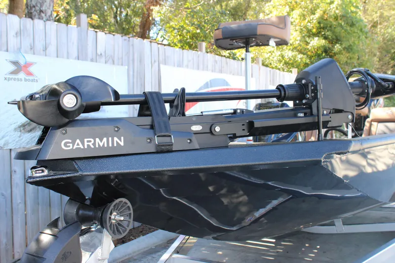 Slide: The Image of 2026 Xpress X21 Pro boat with Garmin trolling motor, parked outdoors. - 22