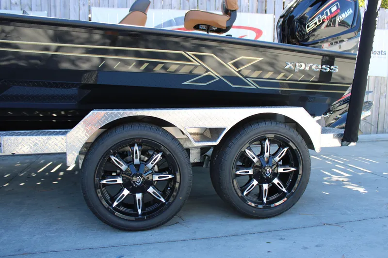 Slide: The Image of 2026 Xpress X21 Pro boat trailer with stylish black alloy wheels. - 24