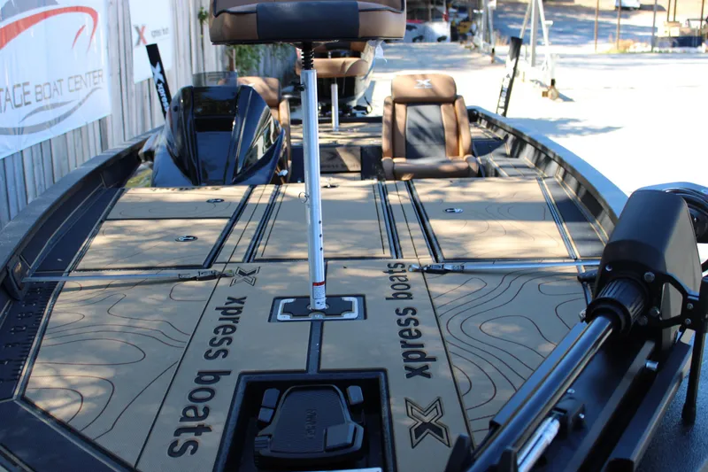 Slide: The Image of 2026 Xpress X21 Pro boat interior with branded deck and seating. - 25