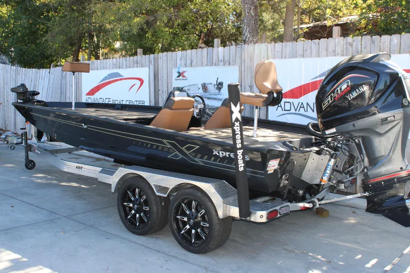Slide: The Image of 2026 Xpress X21 Pro boat on trailer with Yamaha engine, parked outdoors. - 3