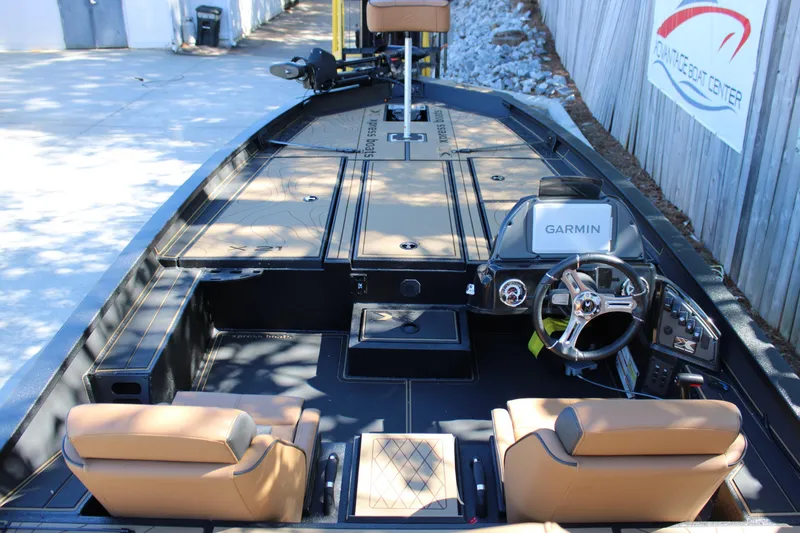 Slide: The Image of 2026 Xpress X21 Pro boat interior with Garmin navigation system and tan seating. - 6