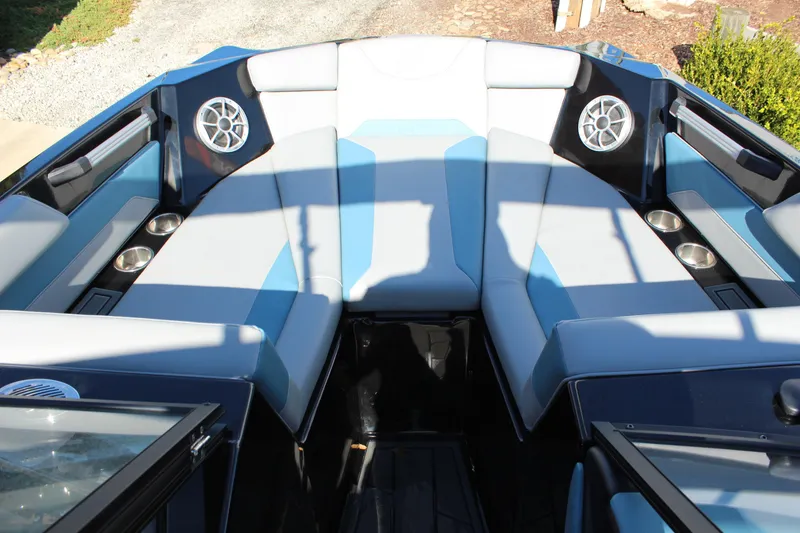 Slide: The Image of 2024 ATX Surf Boats 22 Type-S interior with blue and gray seating and cup holders. - 12