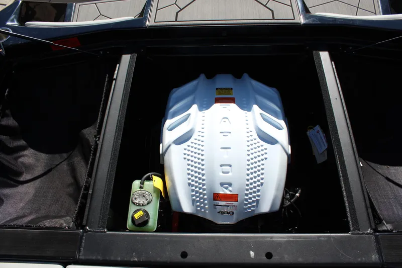 Slide: The Image of 2024 ATX Surf Boats 22 Type-S engine compartment with white cover and components. - 13