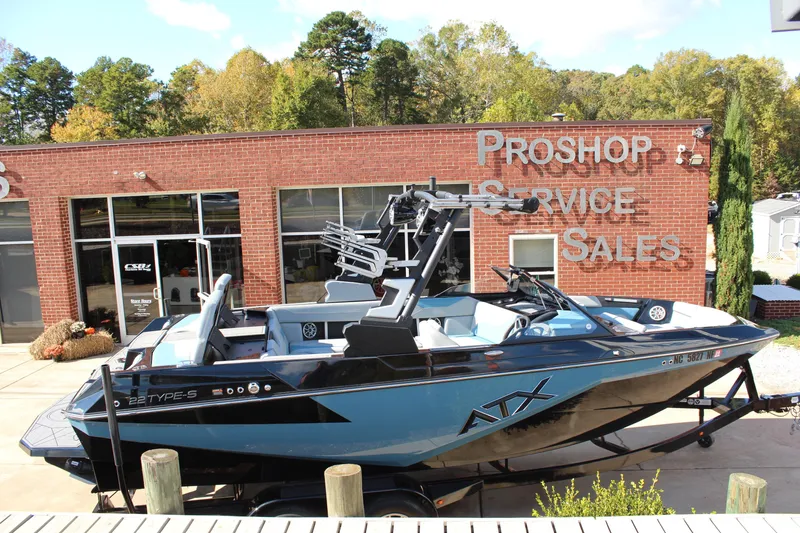 Slide: The Image of 2024 ATX Surf Boats 22 Type-S displayed outside a pro shop with service and sales signage. - 14