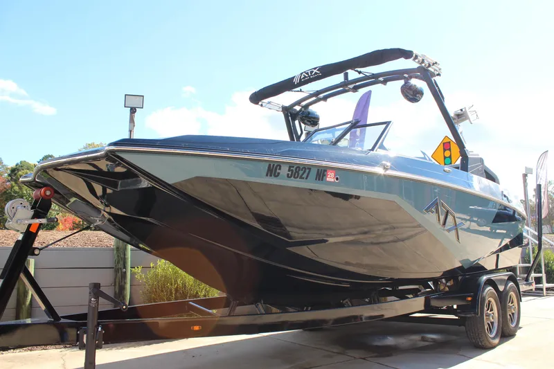 Slide: The Image of 2024 ATX Surf Boats 22 Type-S on trailer, sleek design under sunny sky. - 16