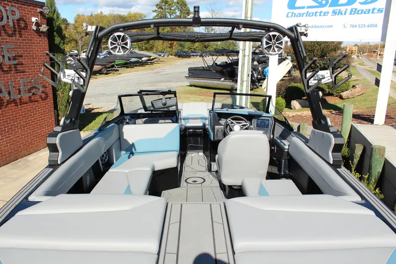 Slide: The Image of 2024 ATX Surf Boats 22 Type-S interior with seating and steering wheel, displayed outdoors. - 5