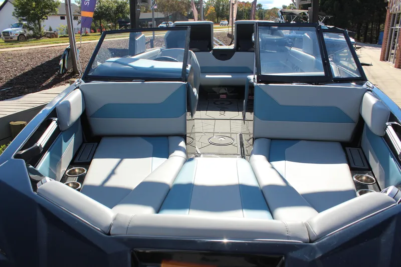 Slide: The Image of 2024 ATX Surf Boats 22 Type-S interior with blue and white seating, open layout. - 9