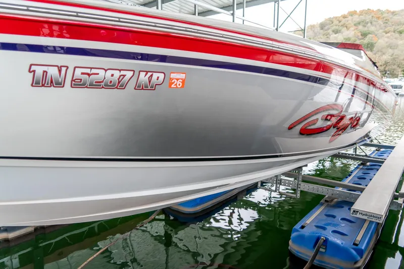 Slide: The Image of 2000 Baja 36 Outlaw boat on lift, displaying registration number TN 5287 KP. - 13