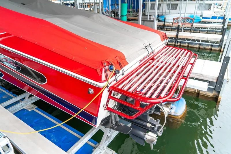 Slide: The Image of Red 2000 Baja 36 Outlaw boat docked with cover and swim platform. - 18