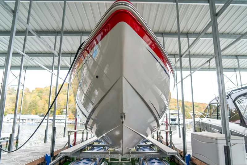 Slide: The Image of 2000 Baja 36 Outlaw boat docked in a covered marina, front view. - 21