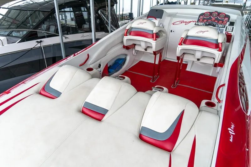 Slide: The Image of 2000 Baja 36 Outlaw boat interior with red and white seating and dashboard. - 22