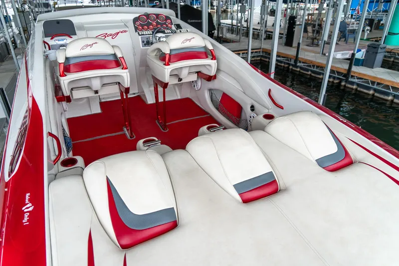 Slide: The Image of 2000 Baja 36 Outlaw boat interior with red and white seating and dashboard. - 23