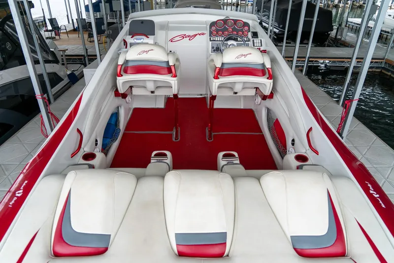 Slide: The Image of 2000 Baja 36 Outlaw boat interior with red and white seating and dashboard. - 25