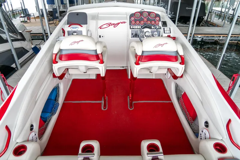 Slide: The Image of 2000 Baja 36 Outlaw boat interior with red and white seating and dashboard. - 26