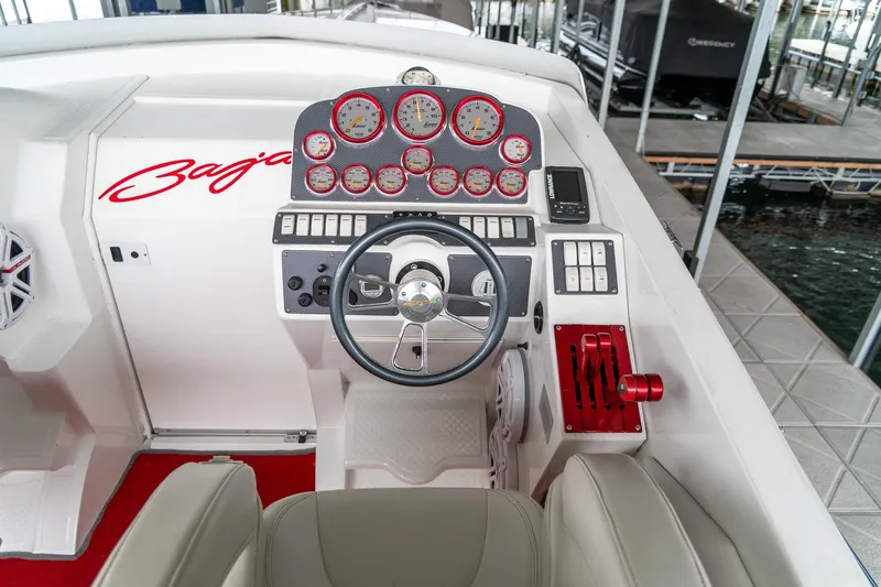 Slide: The Image of Cockpit of 2000 Baja 36 Outlaw boat with steering wheel and gauges. - 31