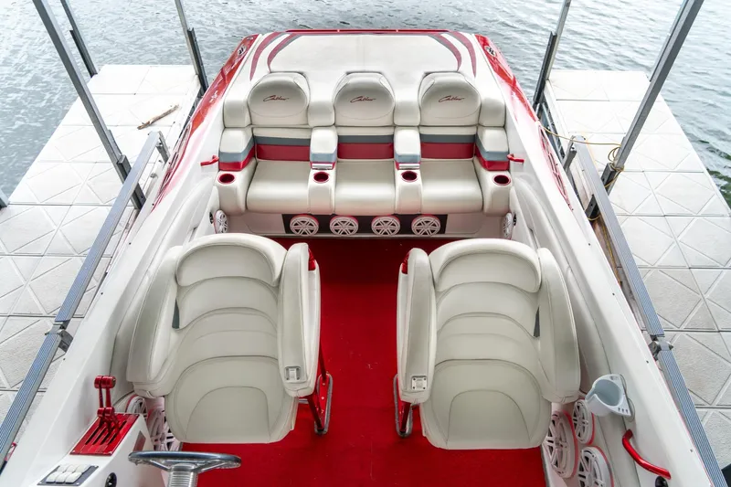 Slide: The Image of 2000 Baja 36 Outlaw boat interior with white and red seating, docked by water. - 37
