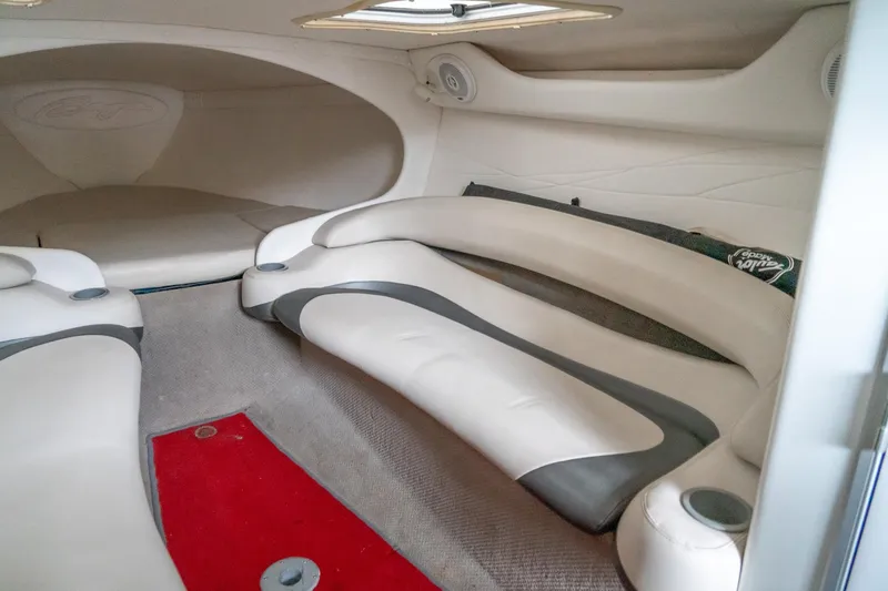 Slide: The Image of Interior of 2000 Baja 36 Outlaw boat with white seating and red carpet. - 42