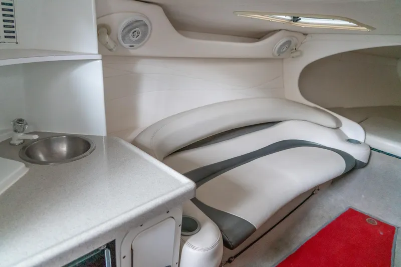 Slide: The Image of Interior of a 2000 Baja 36 Outlaw boat with seating and sink. - 43